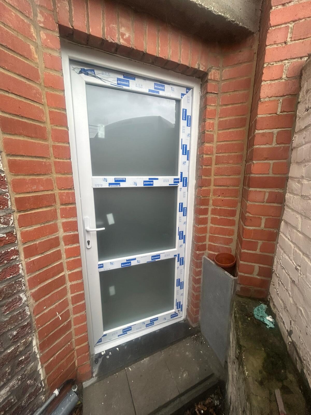 Porte de service PVC sur mesure DECEUNINCK posée en façade